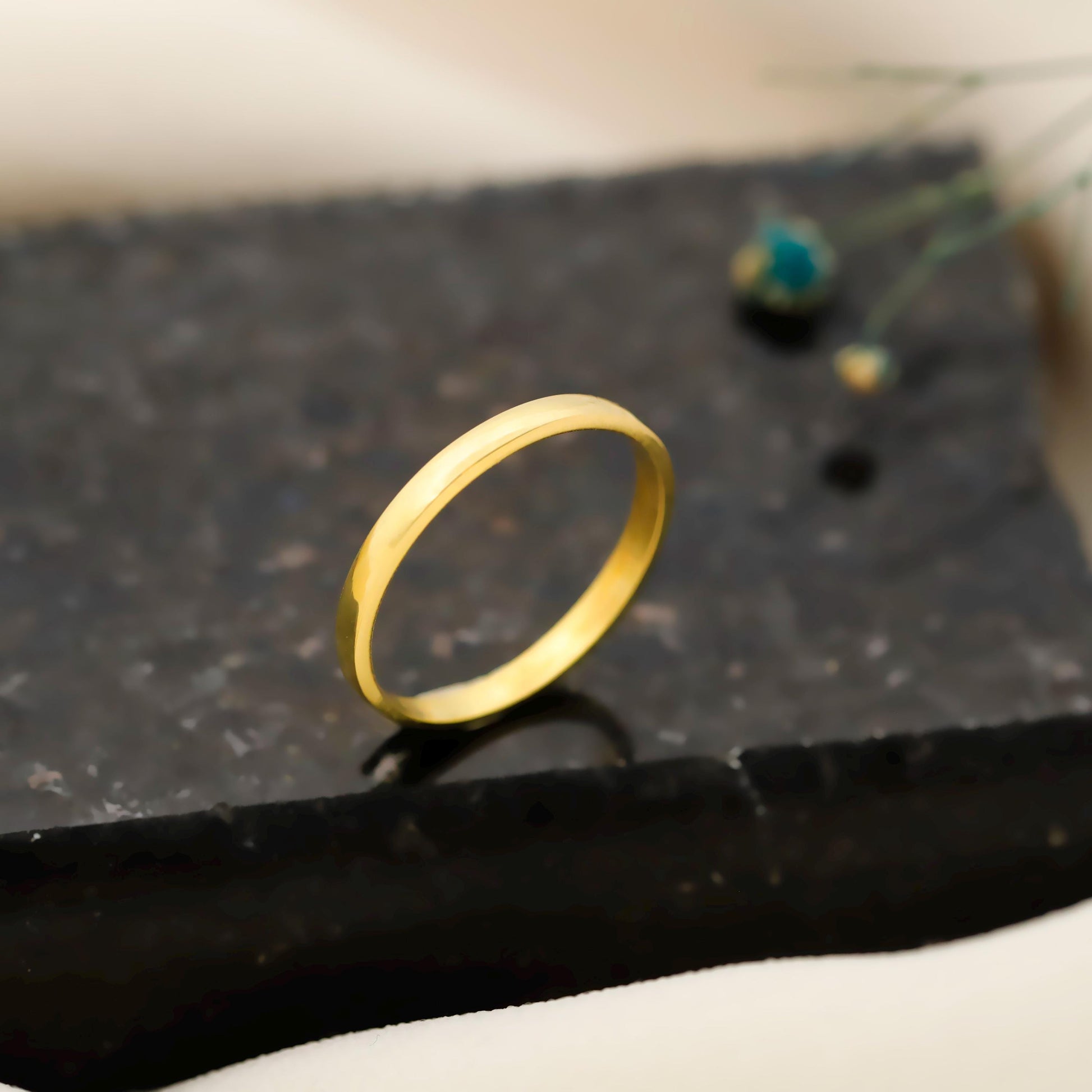 Gold ring on a dark textured surface