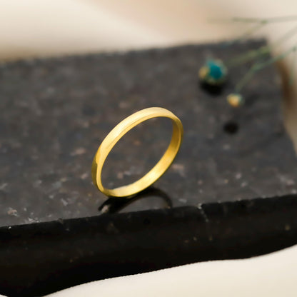 Gold ring on a dark textured surface