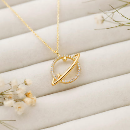 Gold necklace with a unique pendant on a soft beige background