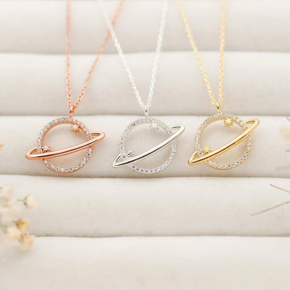 Three necklaces with circular pendants in rose gold, silver, and gold on a light background.