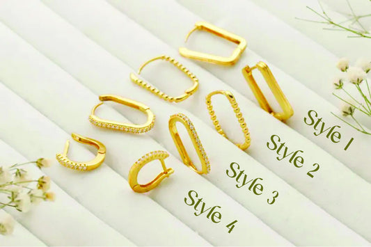 Set of gold hoop earrings on a white background with floral elements