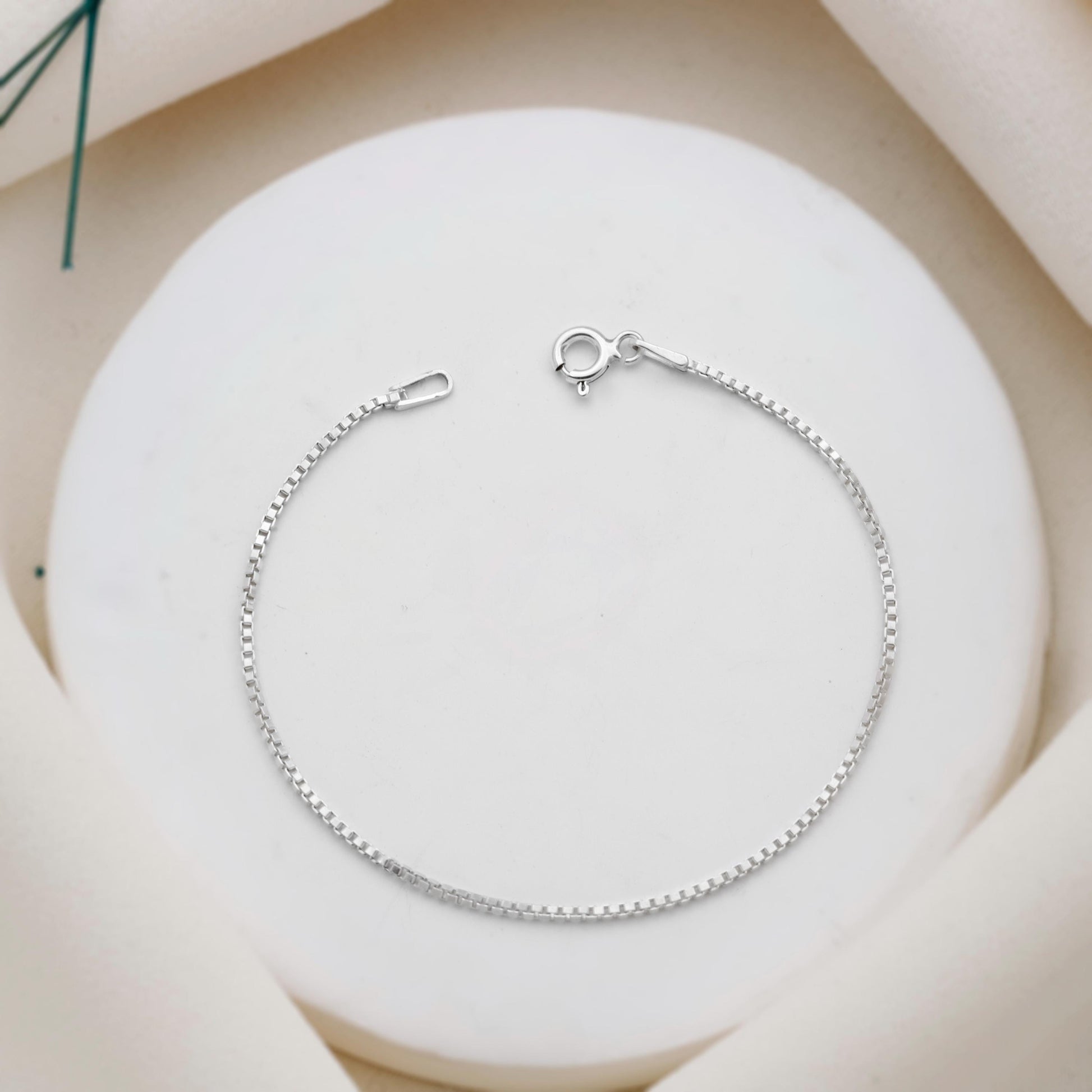 Silver bracelet on a white stone surface