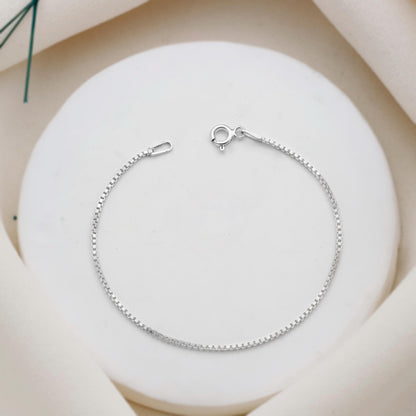 Silver bracelet on a white stone surface