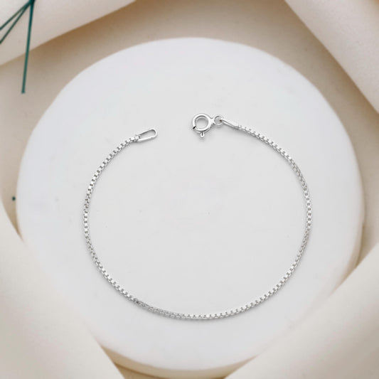 Silver bracelet on a white stone surface