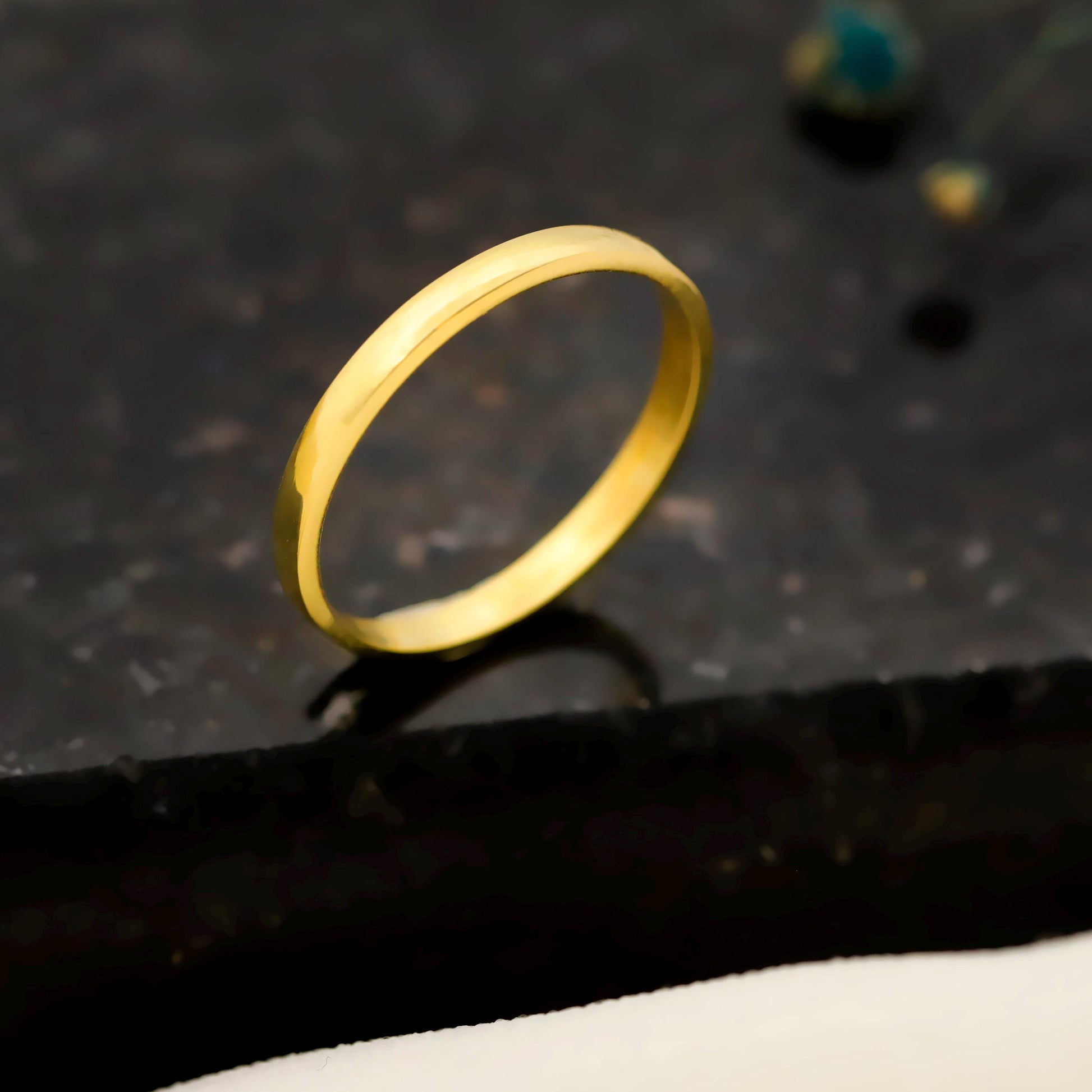 Gold ring on a dark textured surface