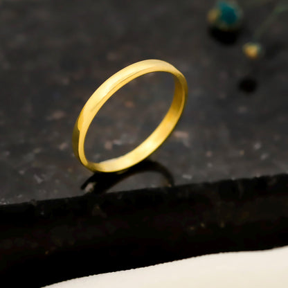 Gold ring on a dark textured surface