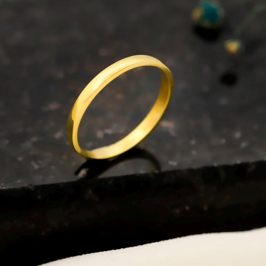 Gold ring on a dark textured surface