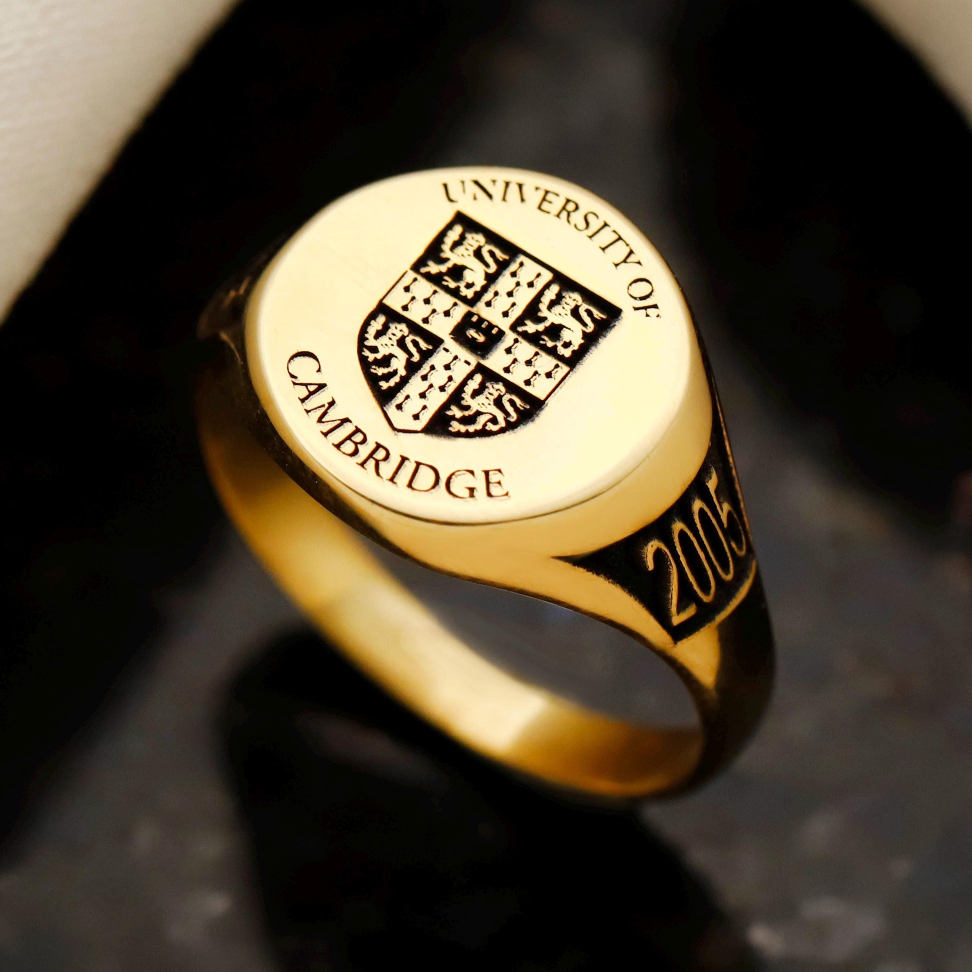 Gold ring with 'University of Cambridge' emblem and year '2005'