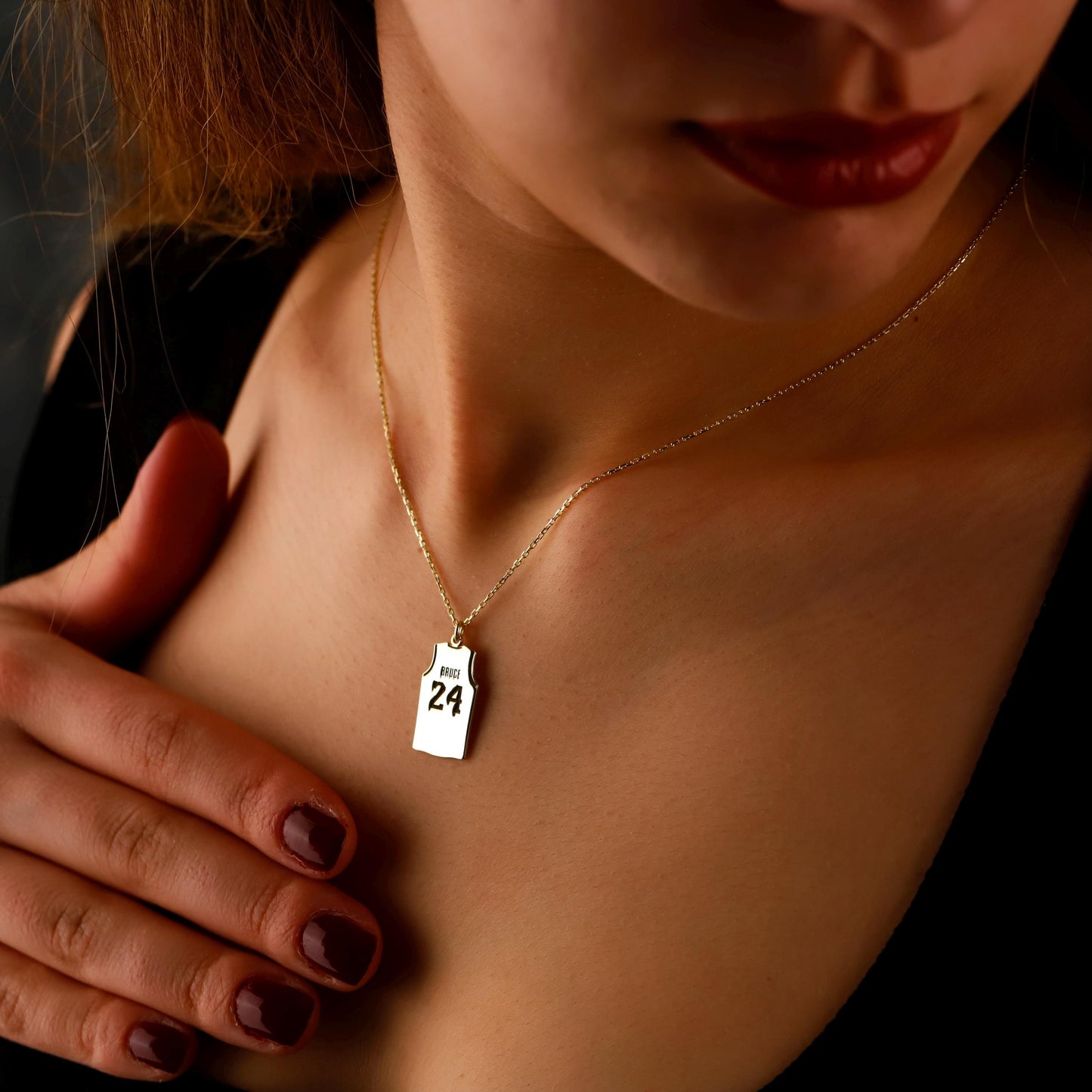 Necklace with a small pendant worn by a person