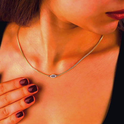 Close-up of a necklace on a person's neck with a blurred background