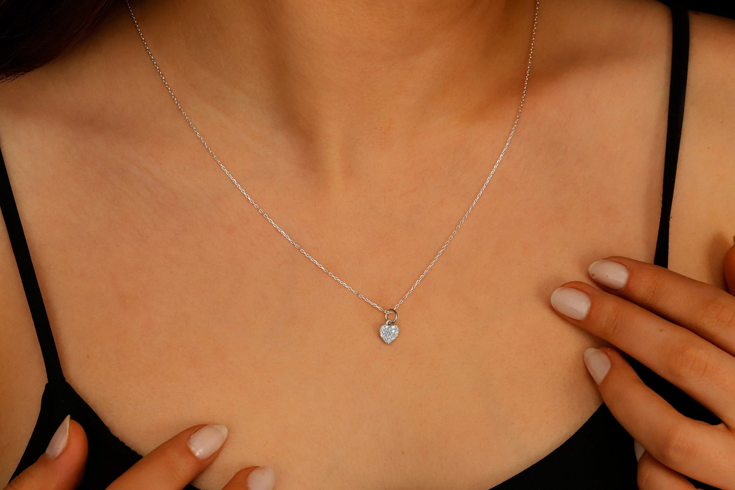 Silver necklace with a pendant on a person's neck