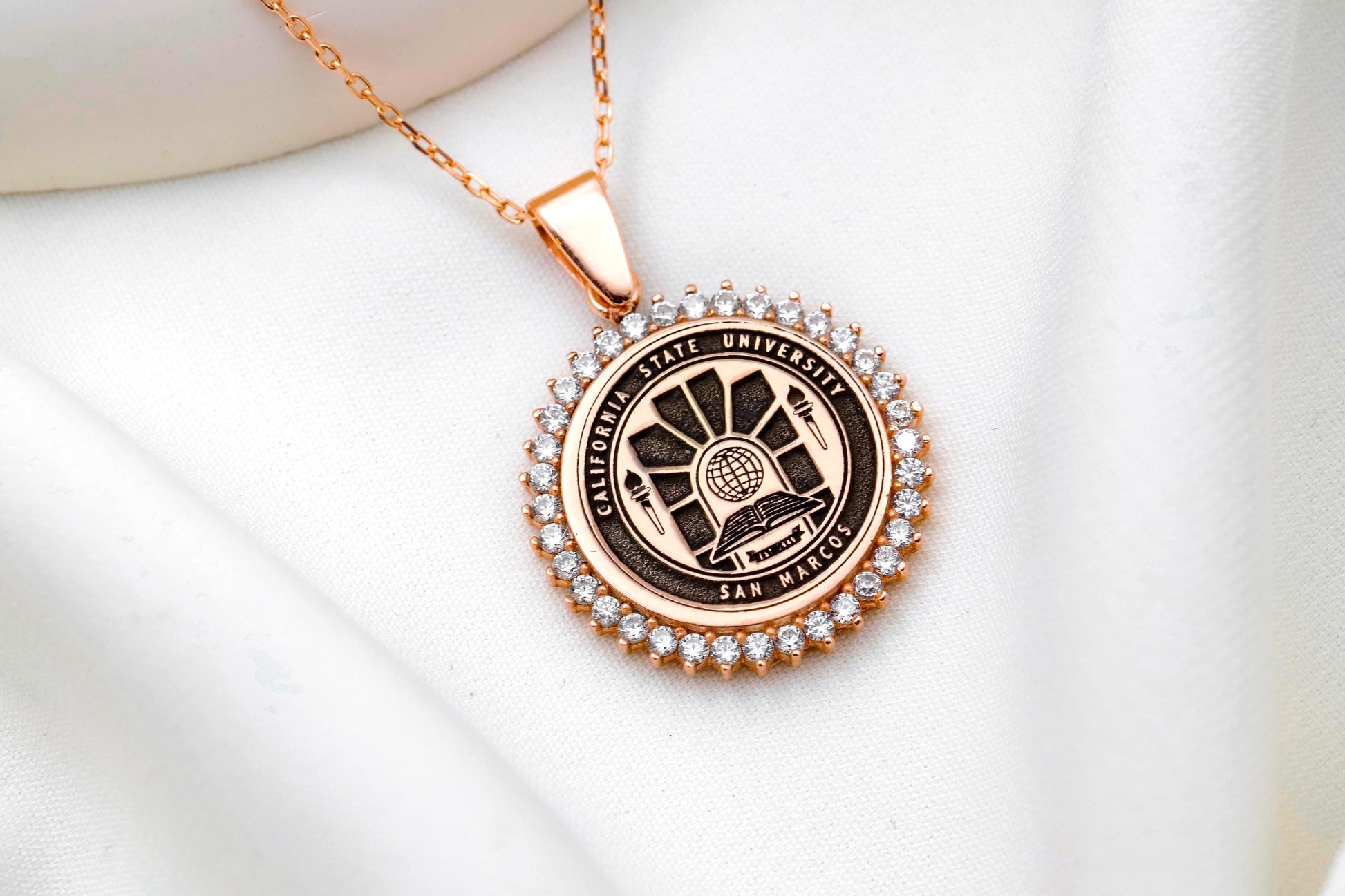 Rose gold necklace with a pendant on a white background