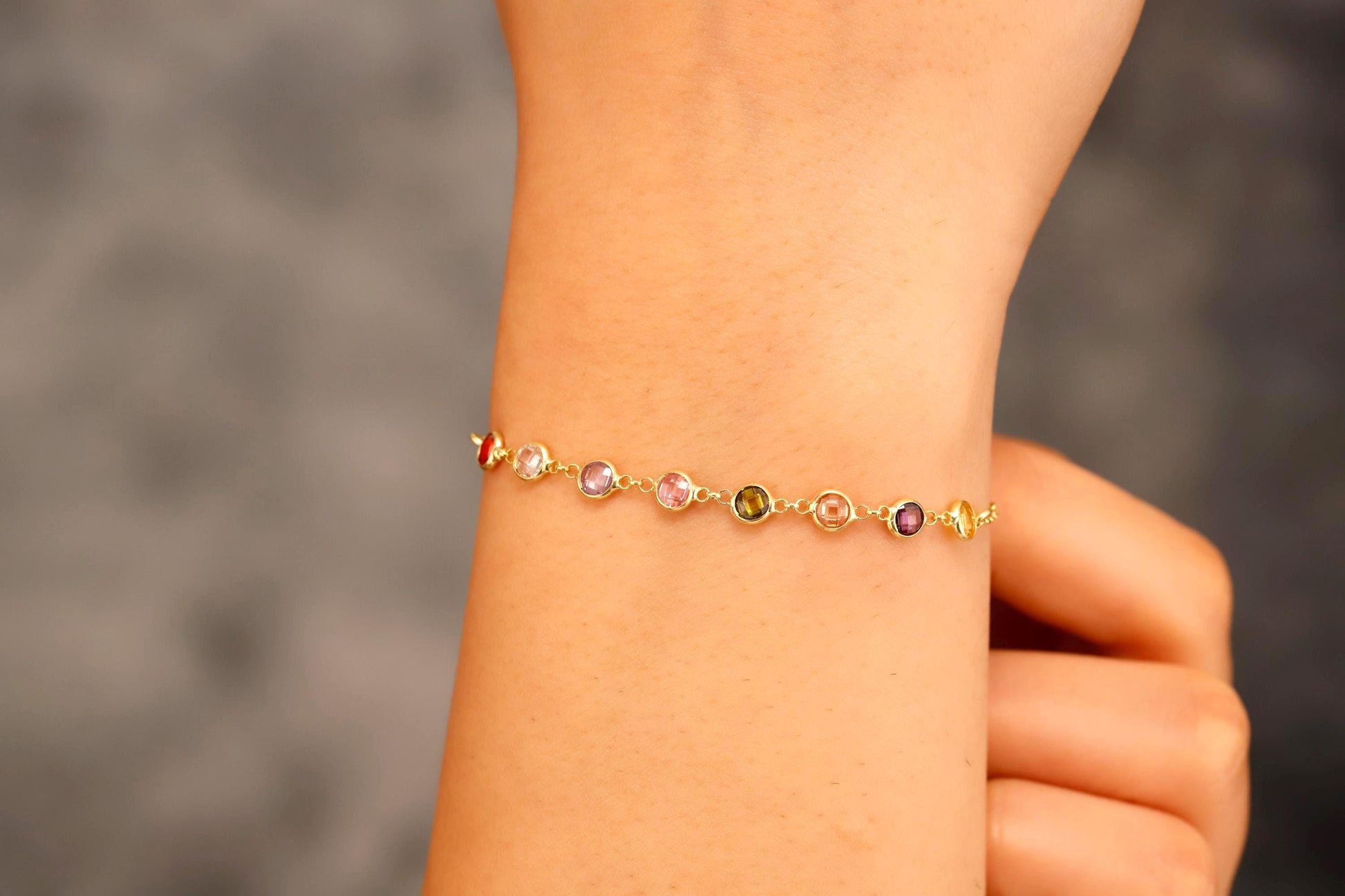 Bracelet with small beads on a wrist against a blurred background