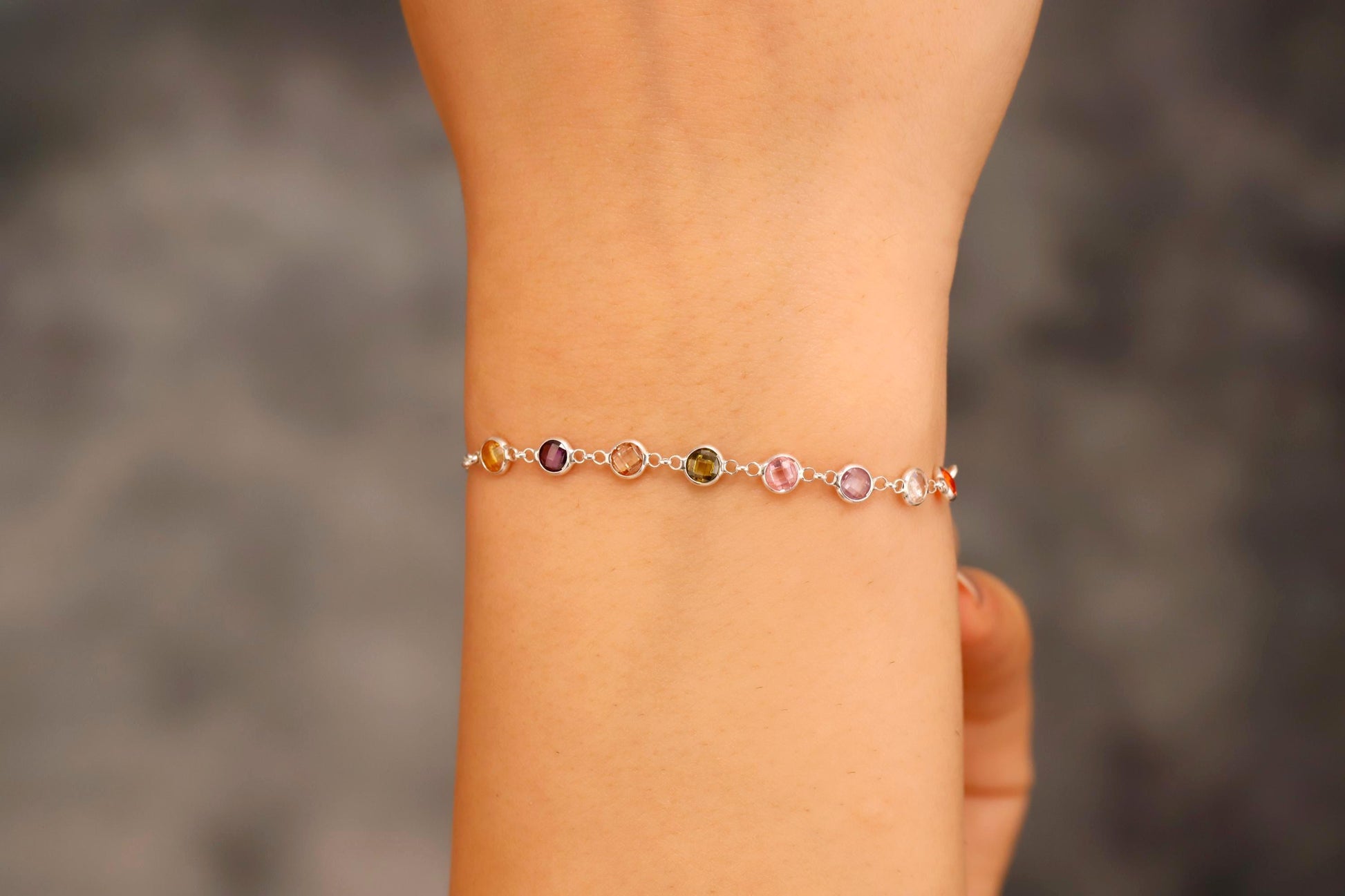 Multicolored beaded bracelet on a wrist with a blurred background