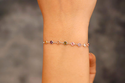 Multicolored beaded bracelet on a wrist with a blurred background