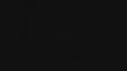 A close-up image of a person's finger wearing a college seal engraving signet ring.