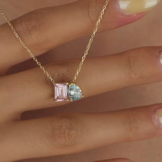 Necklace with pink and blue gemstones on a skin background