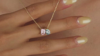Necklace with pink and blue gemstones on a skin background