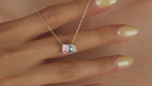 Necklace with pink and blue gemstones on a skin background