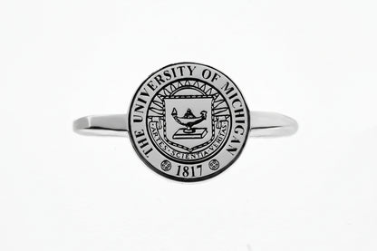 Silver rings with The University of Michigan crest on a white background