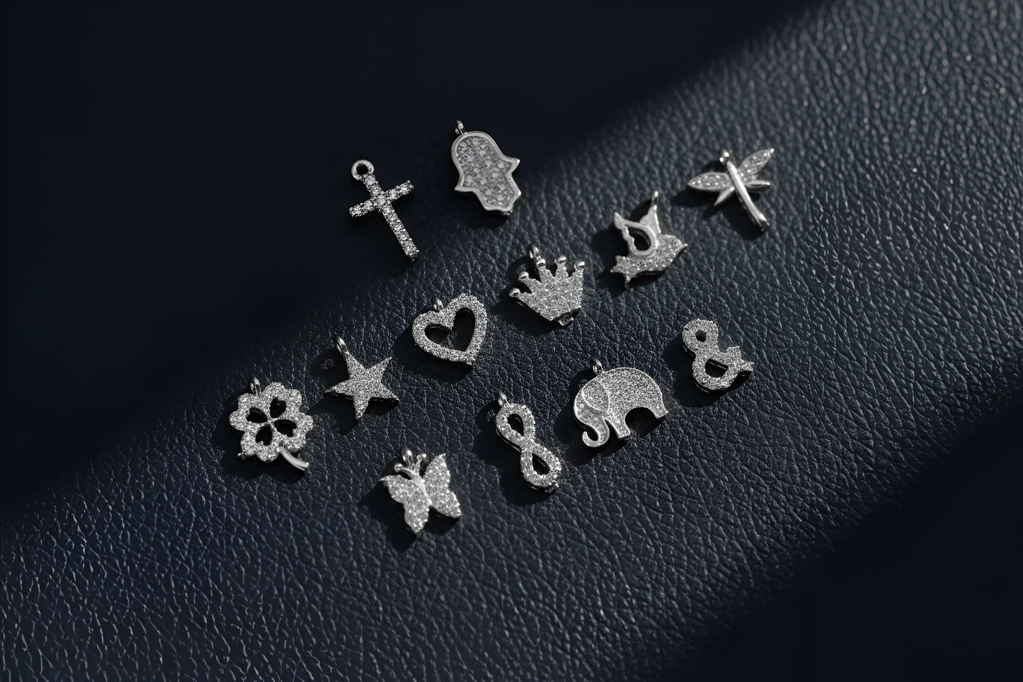 Collection of silver earrings on a dark textured surface