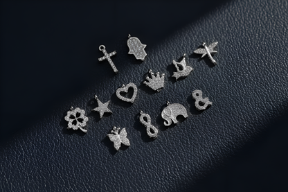 Collection of silver earrings on a dark textured surface